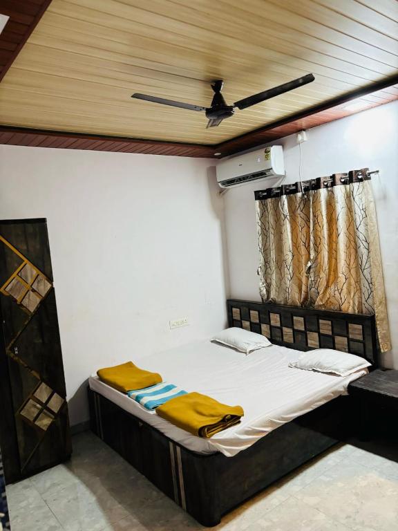 a bed in a room with a ceiling at YR'S Nature Farmhouse in Badlapur
