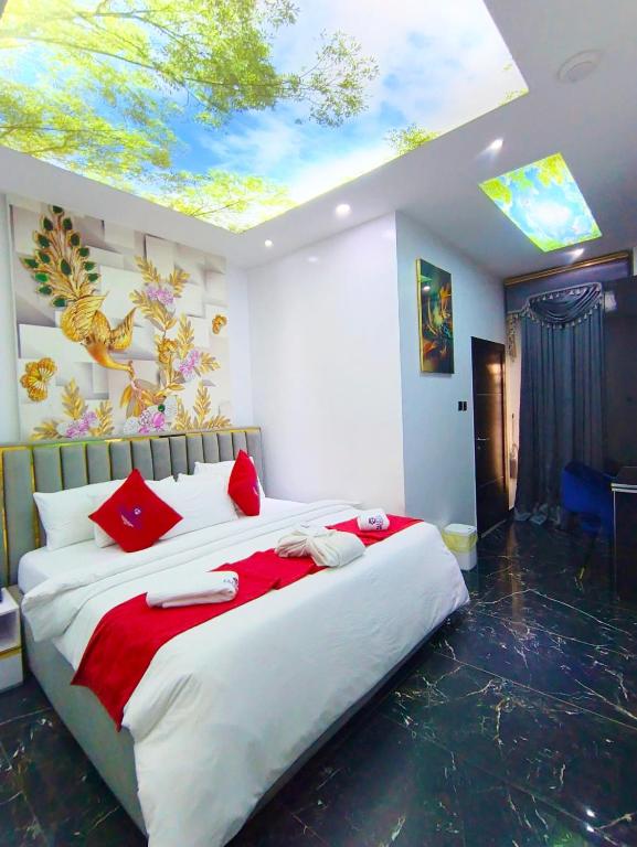 a bedroom with a large bed with a skylight at Fairtex Luxury Hotels in Maiyegun