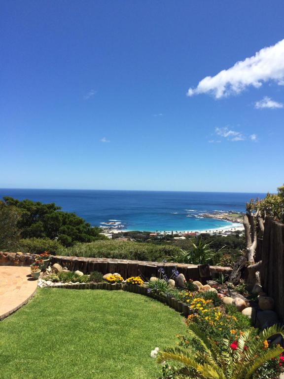 a garden with a view of the ocean at Camps Bay Villa in Cape Town