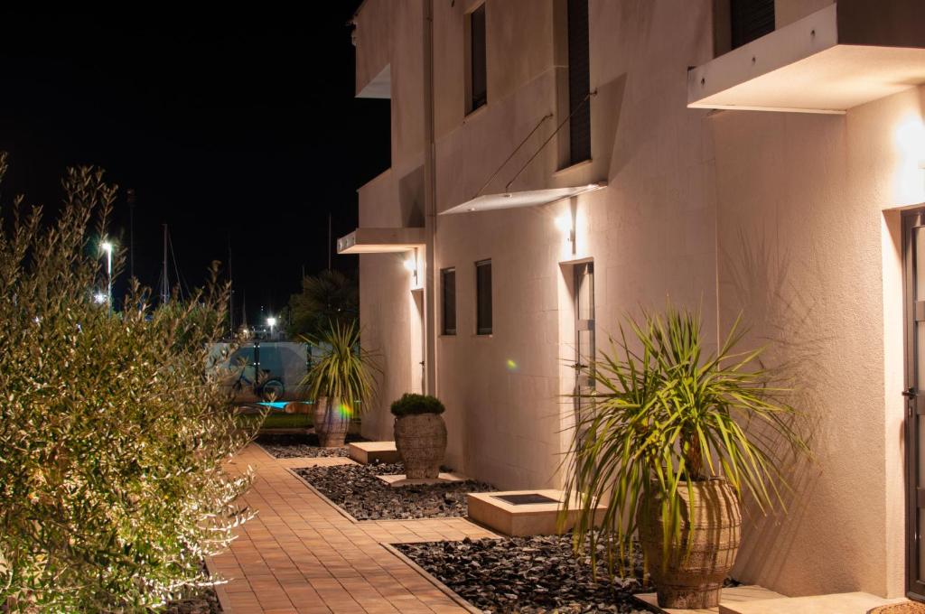 a building with plants in front of it at night at Villa Martina in Novigrad Istria