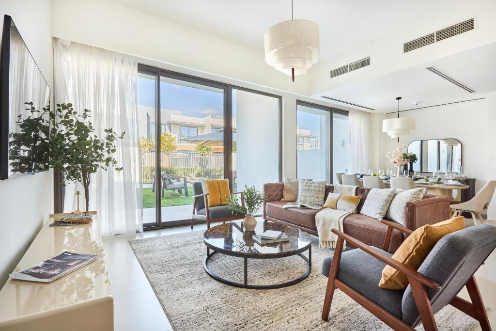 a living room with a couch and a table at Frank Porter - Nara, The Valley in Dubai