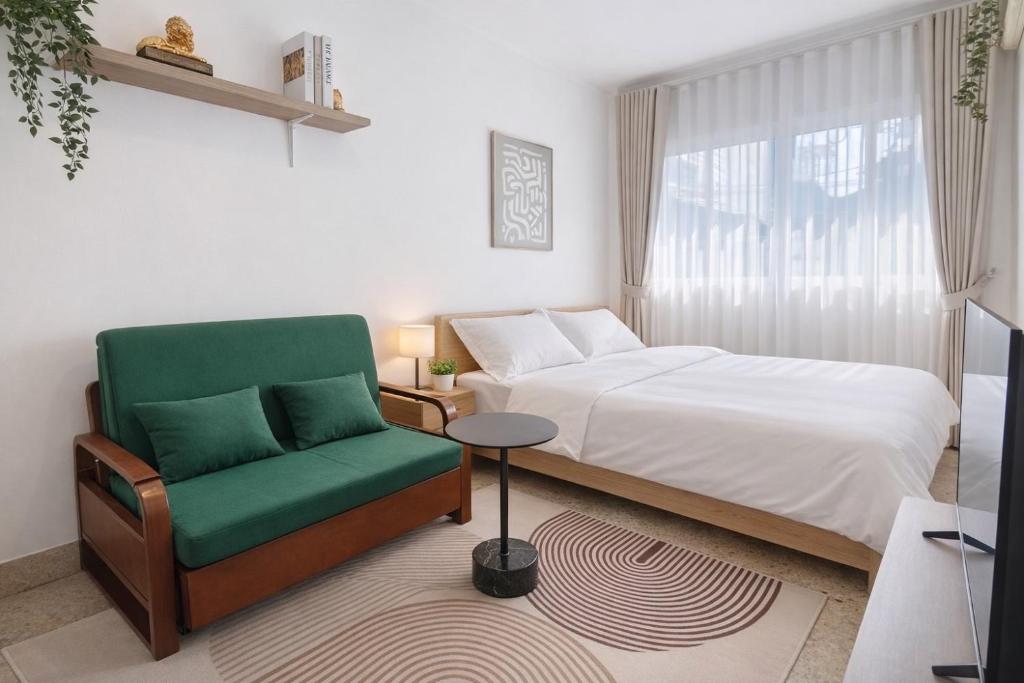 a bedroom with a bed and a chair and a window at 8 Min Walk to IconSiam I BTS near Pier in Bangkok