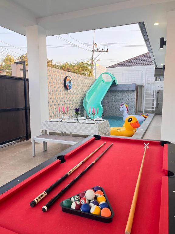 a pool table with cue balls on top of it at Cozy Poolvilla Pattaya in Bang Lamung