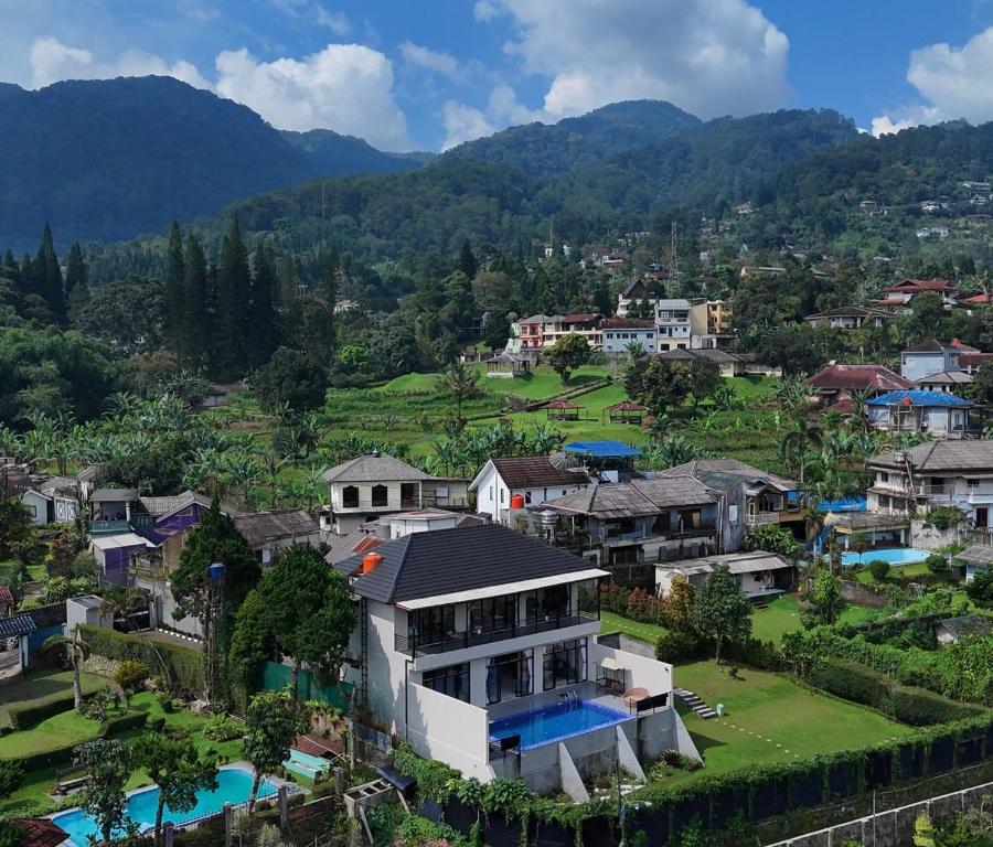 an aerial view of a village with houses and mountains at VILLA NEOM PUNCAk in Sampal 2