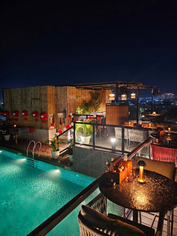 a swimming pool on the roof of a building at night at Comfort Hotel Vista in Lucknow