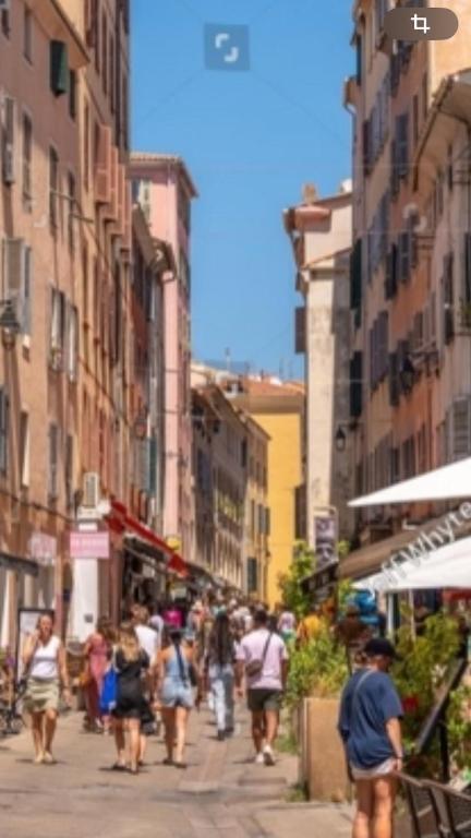 a group of people walking down a city street at F2 rue fesch in Ajaccio