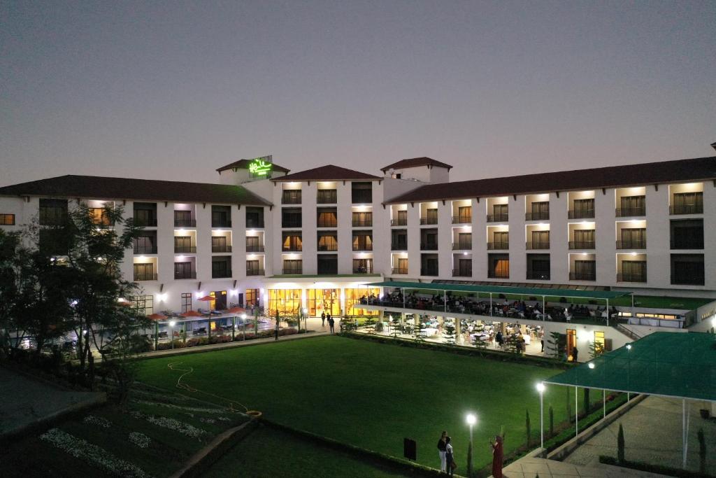 a large building with a large lawn in front of it at Haile Resort Adama in Adama