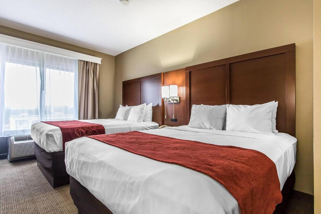 a hotel room with two beds and a window at Comfort Suites Effingham Central in Effingham