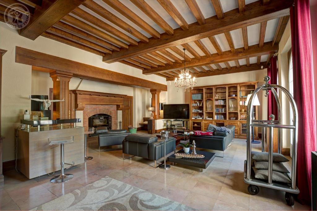 a living room with a couch and a fireplace at Le Clos des Soyeux in Saint-Victor-sur-Rhins