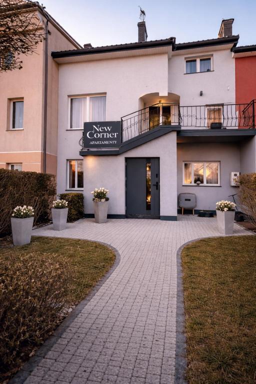 a building with a walkway in front of it at New Corner Apartamenty in Niechorze