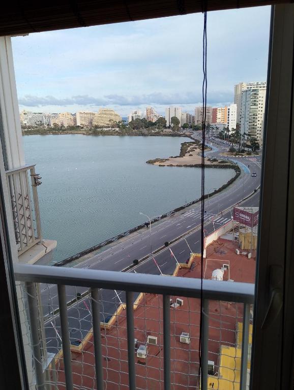 a view of a body of water from a balcony at Cala Morelló in Ifach