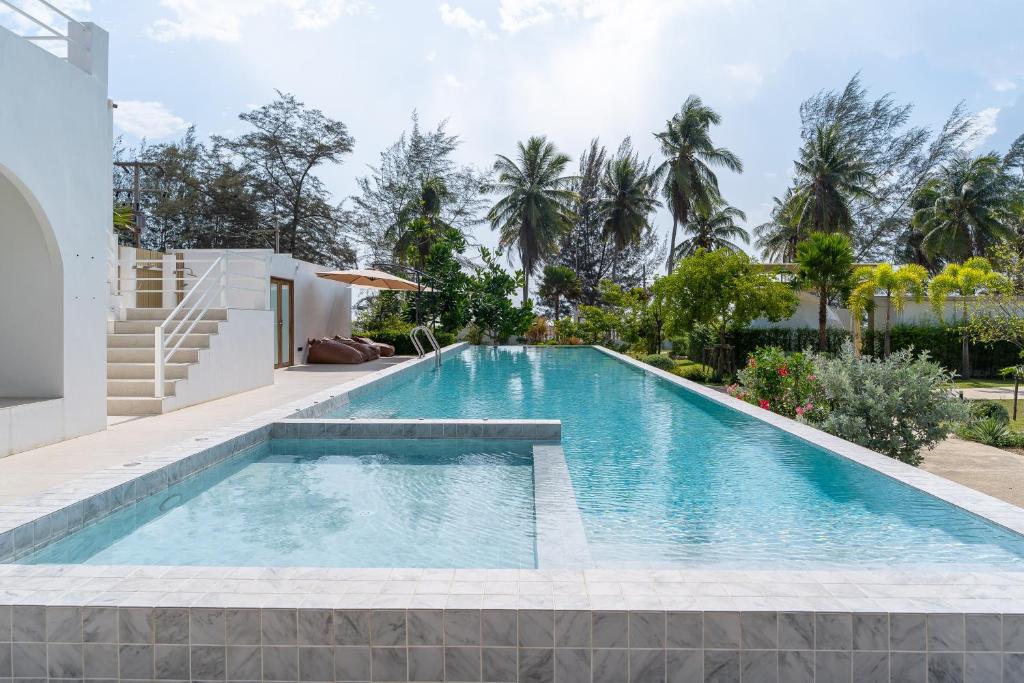 a swimming pool in the backyard of a house at Grood Glamping in Ban Khok Sung