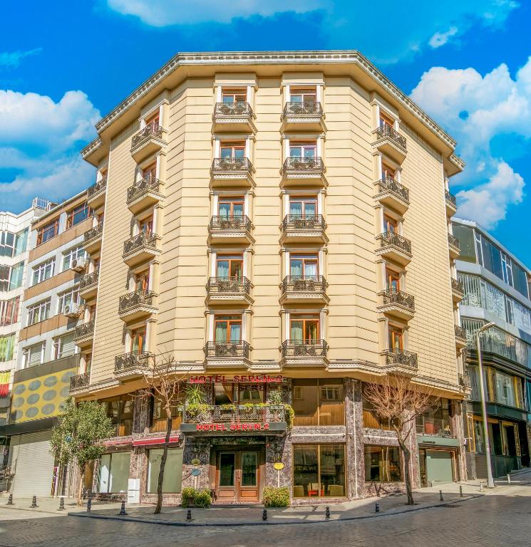 a tall yellow building on a city street at Hotel Seren 2 in Istanbul