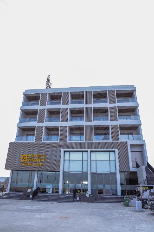 a large building with a sign on the front of it at King's Kraft Shubh Hotel in Dwarka