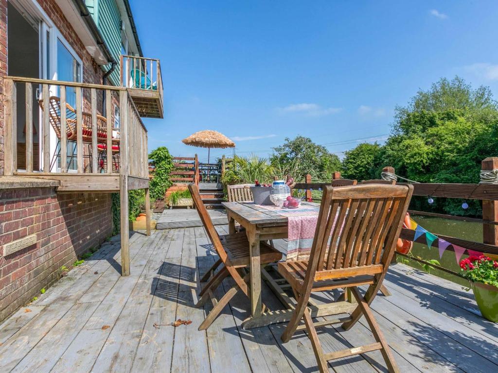 a wooden table and chairs on a deck at Riverside in Stone