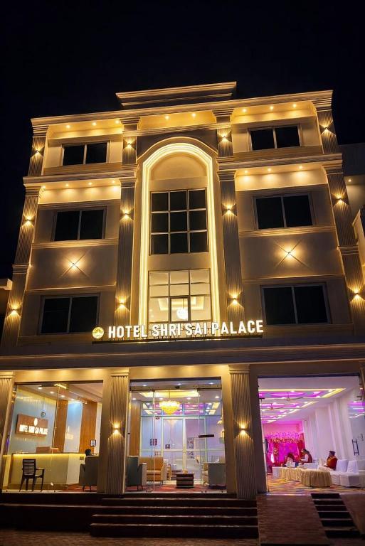 a hotel is lit up at night at Hotel Shri Sai Palace Ayodhya in Faizābād
