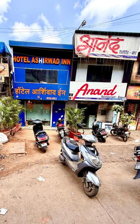 a motor scooter parked in front of a building at Hotel Ashirwad Inn in Mumbai