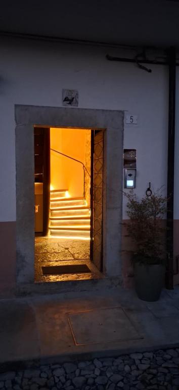 an entrance to a building with a stairway with a light at Corte d'Arnosto - Casa Virginia in Fuipiano Valle Imagna