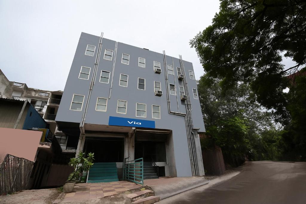 a white building with a blue sign on it at Via Blu Lagoon Inn in New Delhi
