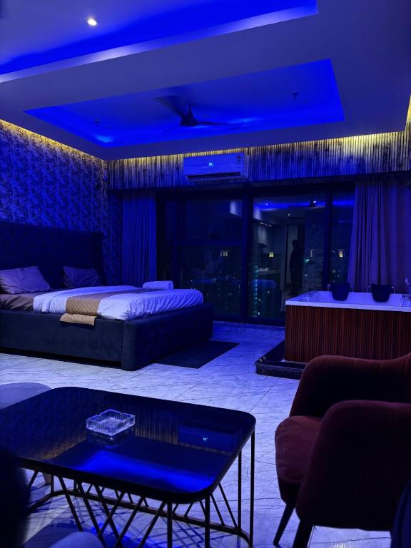 a living room with a bed and a table at Hotel Namaste With Jacuzzi I Best For Couples and Corporate I Noida in Noida