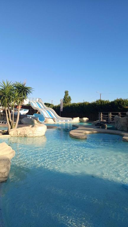 a water slide in a pool in a park at Camping Canet plage mobilhome 4 ou 6 personnes in Canet-en-Roussillon