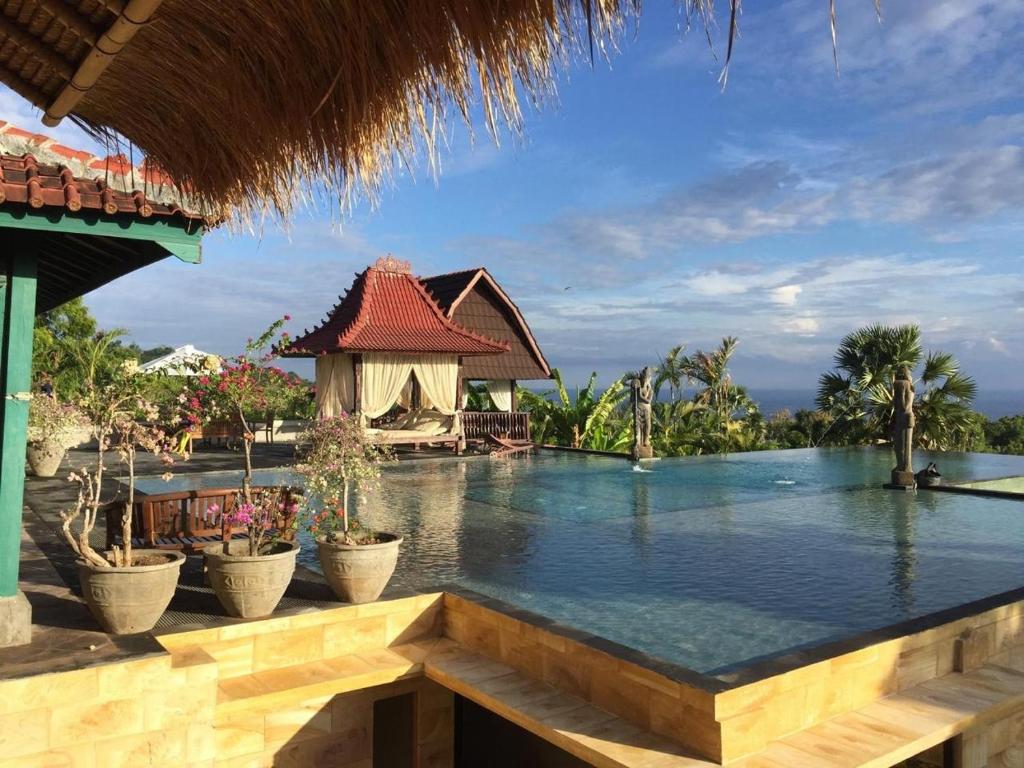 a swimming pool at a resort with a resort at Singa Villas in Ungasan