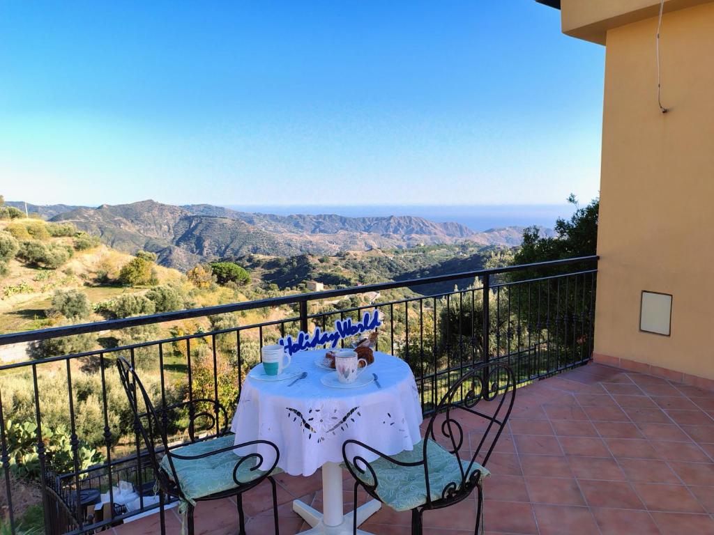a table on a balcony with a view of the mountains at Casa Gioele by Holiday World in Bove