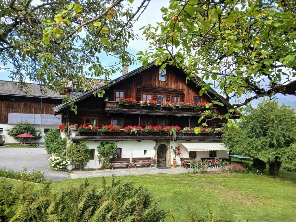 a house with flowers on the front of it at Hinterburghof in Saalfelden am Steinernen Meer