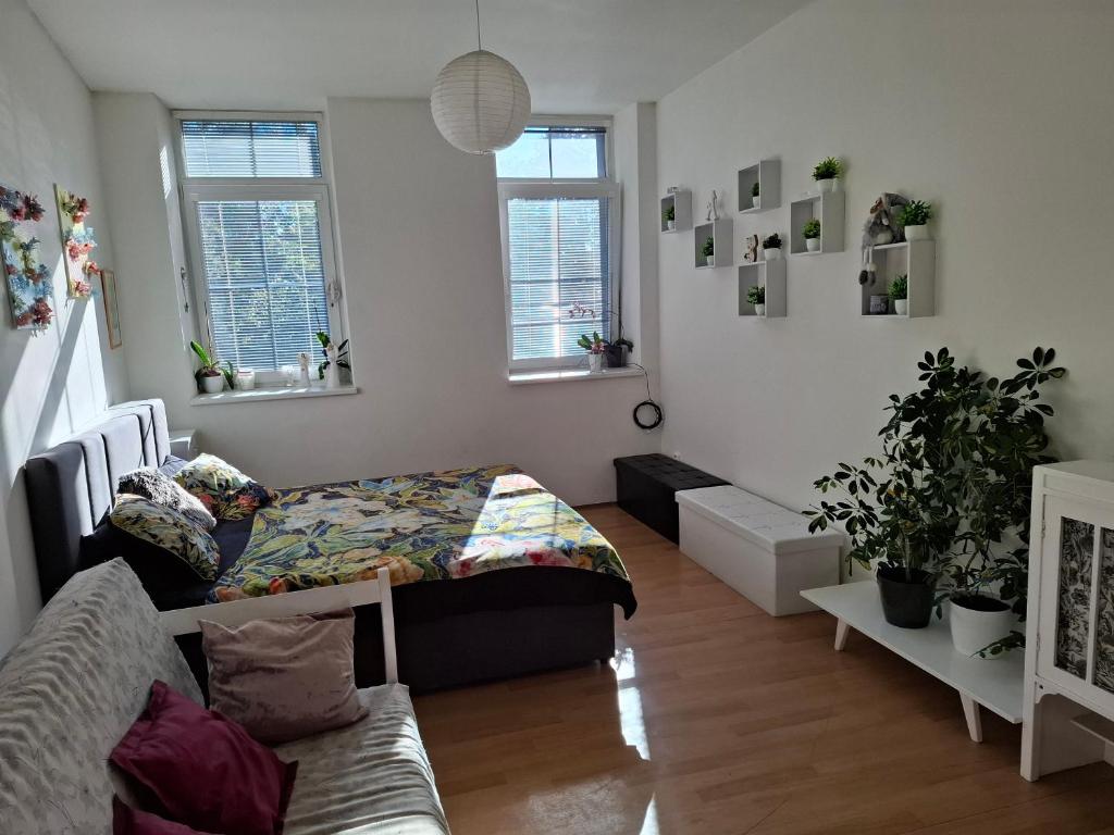 a bedroom with a bed and a couch in it at Apartmán u parku in Prostějov