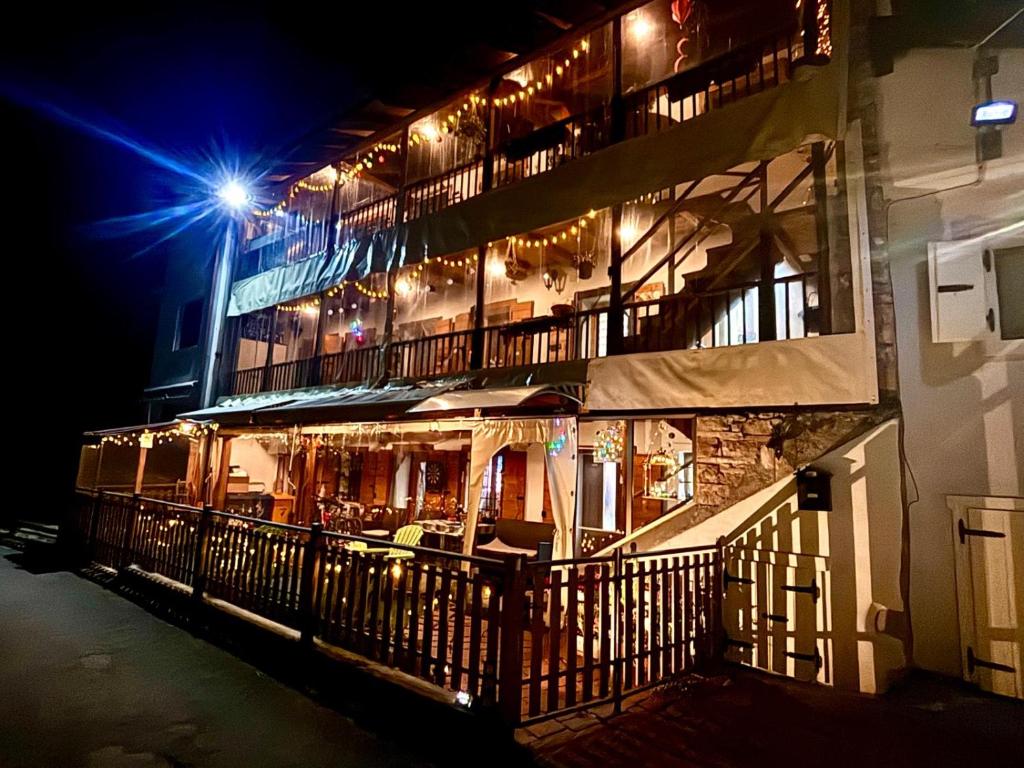 a building with a restaurant with a balcony at night at Casa Gallo Music Room in Lamon