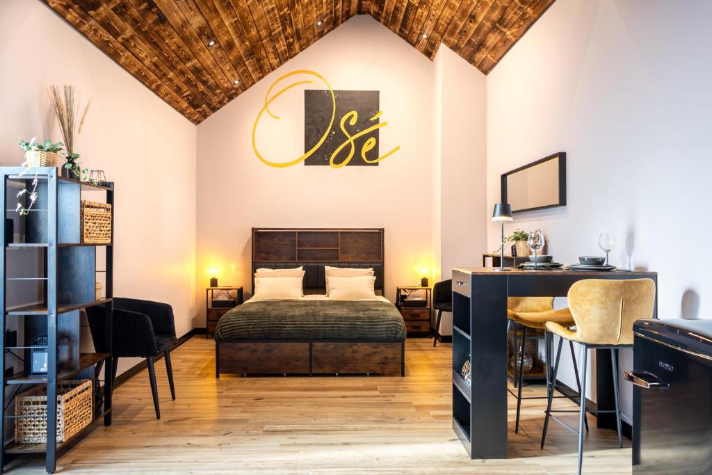 a bedroom with a bed and a table and chairs at Osé in Chênet