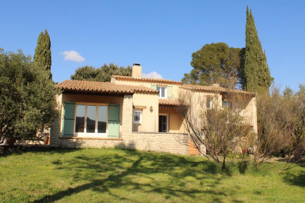 a house in the middle of a field with trees at La villa Cigaliere in Tulette