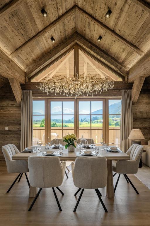 a dining room with a table and chairs and a chandelier at Arnestgut in Strobl
