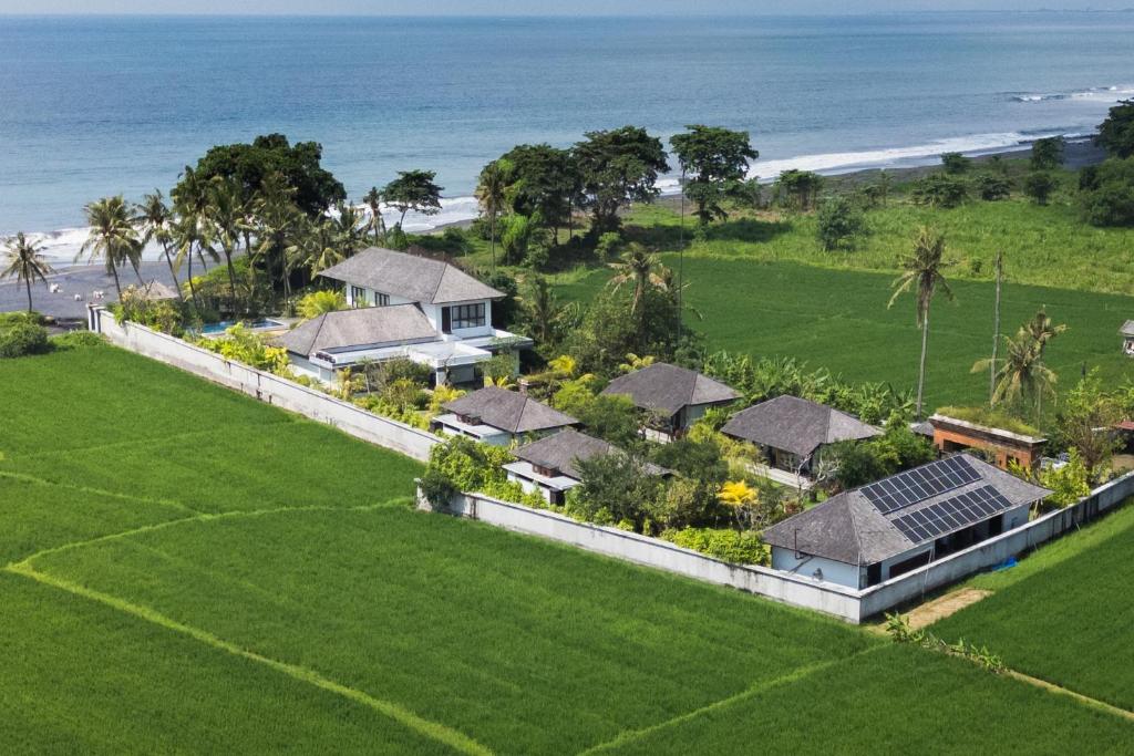 an aerial view of a house on the beach at K Ko Surf Village at Keramas in Lebih