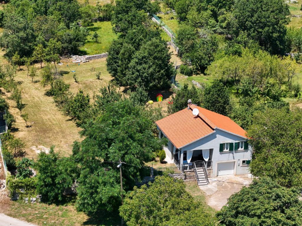 an aerial view of a white house with an orange roof at AnteAna Vrlika Split in Maovice