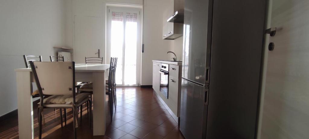 a kitchen with a sink and a table with chairs at Alloggio Tobia in Biella