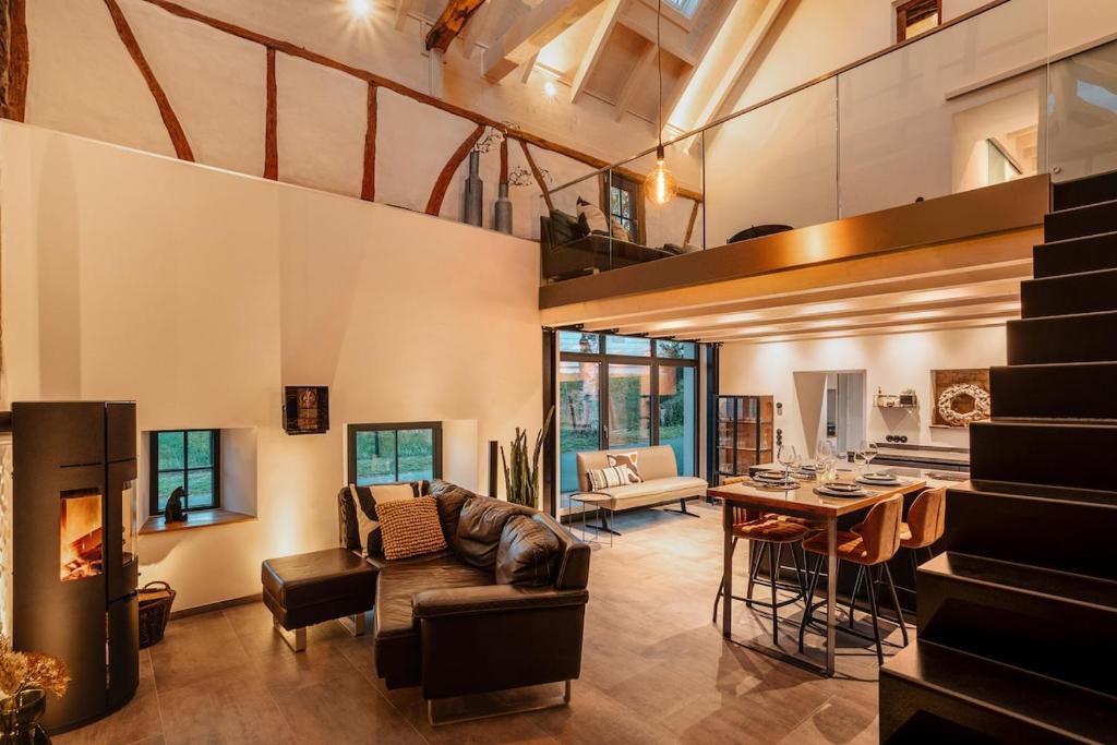 a living room with a couch and a table at Glamorous Cottage mit Kamin und Sauna in Dahlem