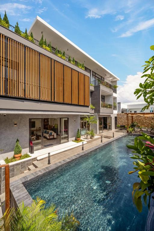 an external view of a house with a swimming pool at Sora Villa, Huge Swimming Pool, Private Sauna & Elevator Access in Danang