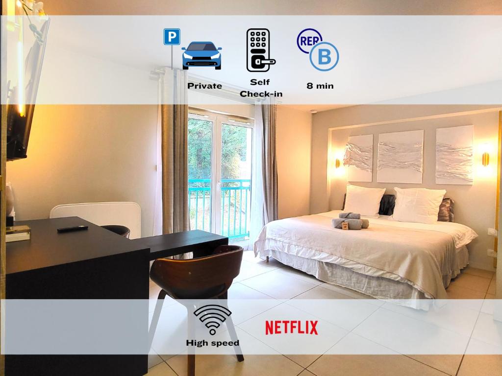 a bedroom with a bed and a desk with a computer at La Parisienne - Spacieux studio avec parking privé in Palaiseau