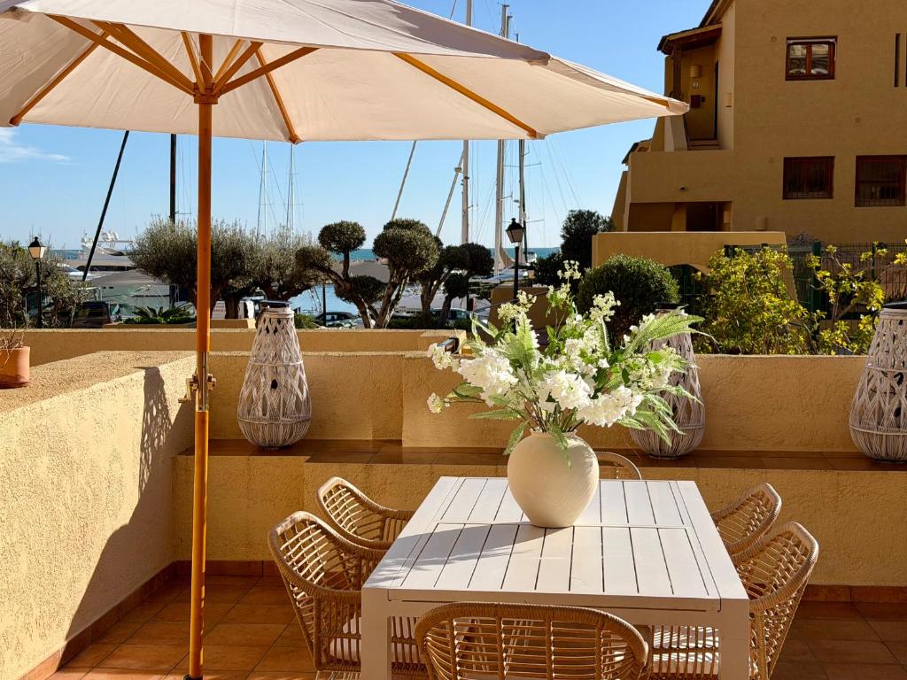 a table with a vase of flowers on a patio at LUXURY ALTEA Campomanes in Altea