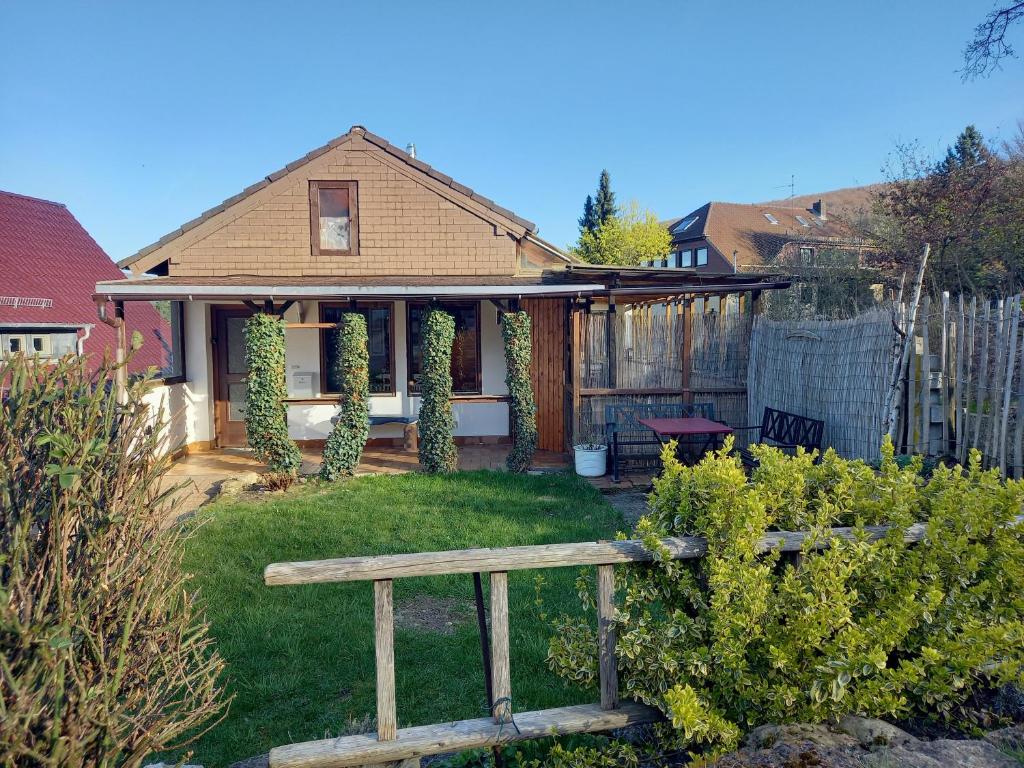 a house with a fence and a yard with a bench at Zwölfenstein mit 3 DTV Sternen ausgezeichnet in Bad Harzburg