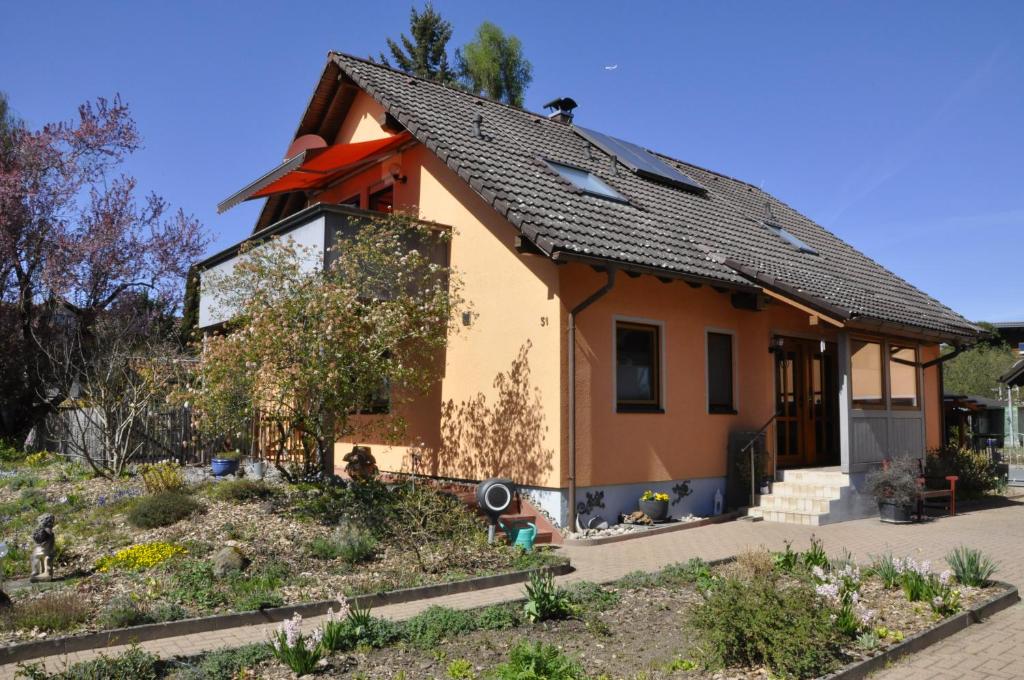 a small house with a garden in front of it at Ferienwohnung am Keltenwall in Jestetten