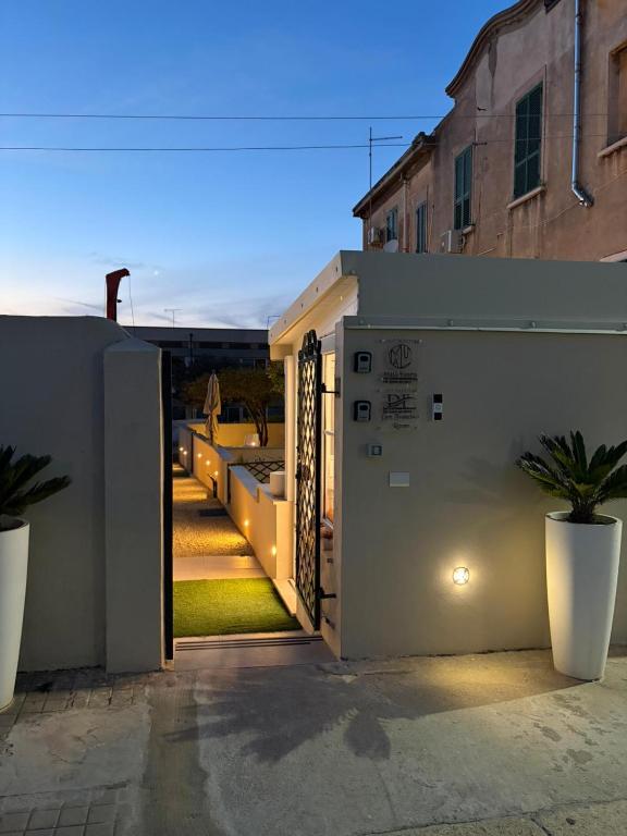 a house with a courtyard at night with a fence at Don Francisco Rooms - TROPEA in Tropea