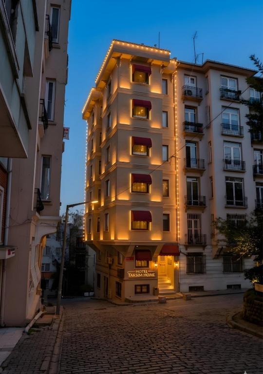 a tall building with lights on the side of it at Hotel Taksim Home in Istanbul