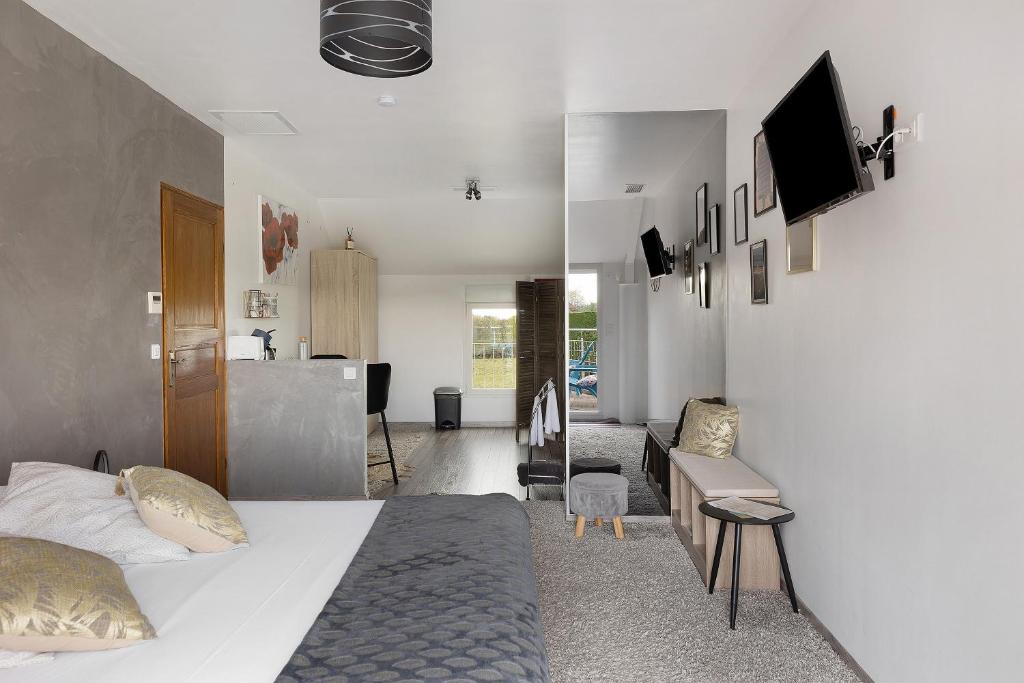a bedroom with a bed and a living room at Chambre D'hôtes Take-off - Chambre in Saint-Georges-sur-Cher
