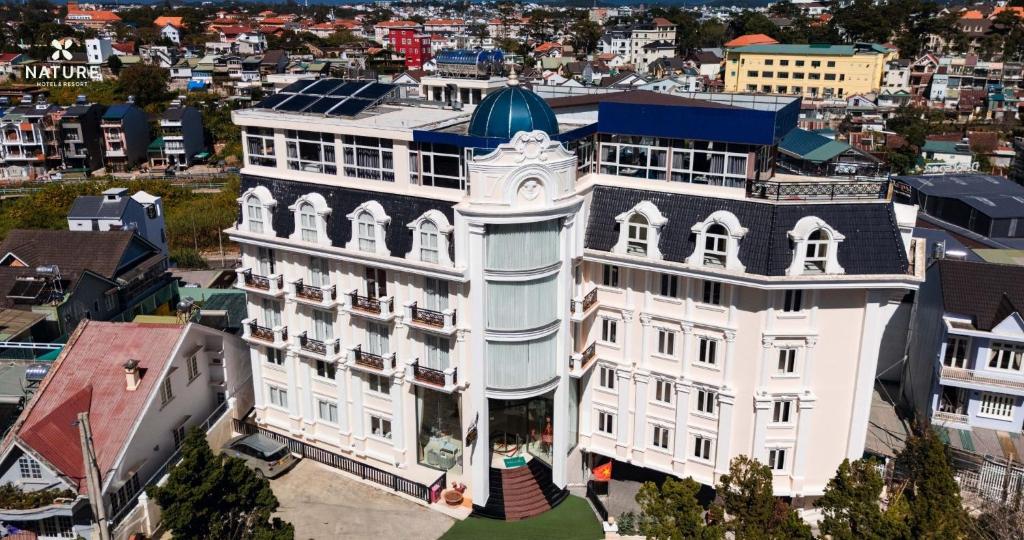 an aerial view of a white building with a clock tower at Nature Hotel - Pham Hong Thai in Da Lat