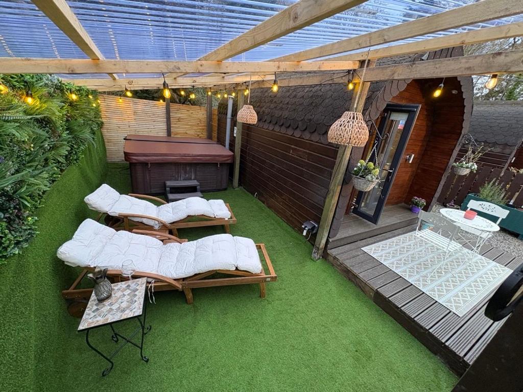 an outdoor patio with four chairs and a table at Go Glamping at Inverness & Loch Ness in Inverness
