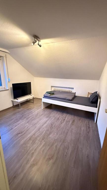 a room with a bed and a flat screen tv at Monteurswohnung Mesum in Rheine