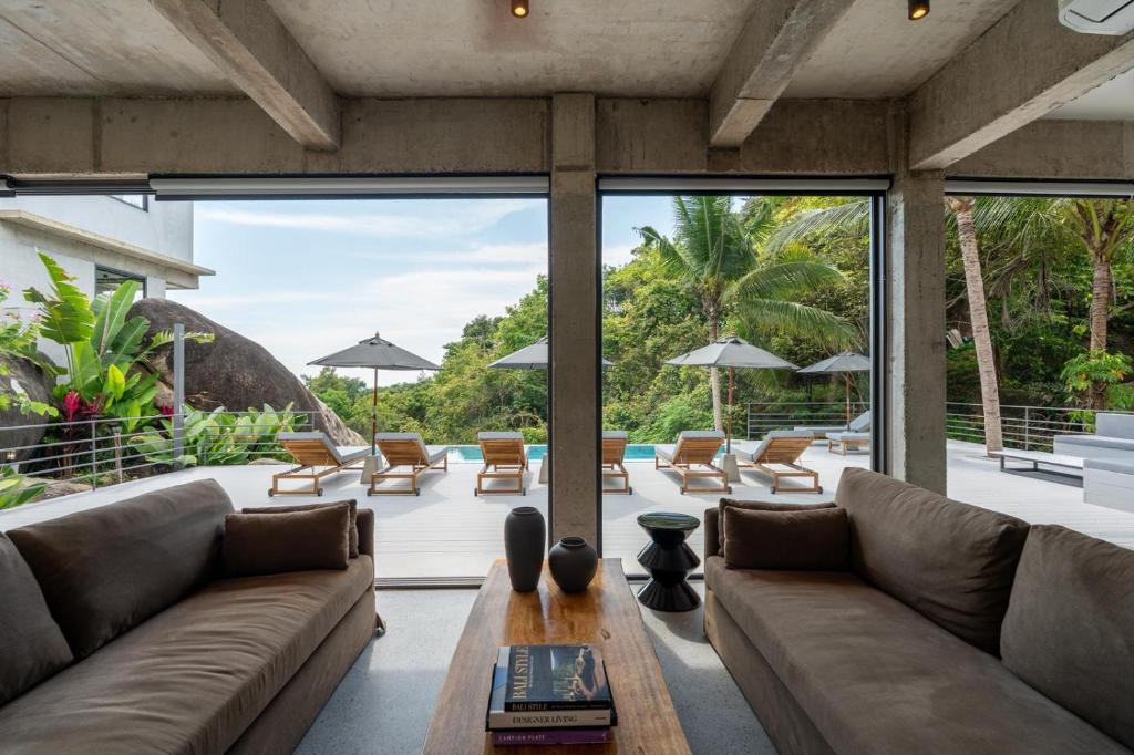 a living room with a couch and a table at Palm Stone Villa in Haad Pleayleam