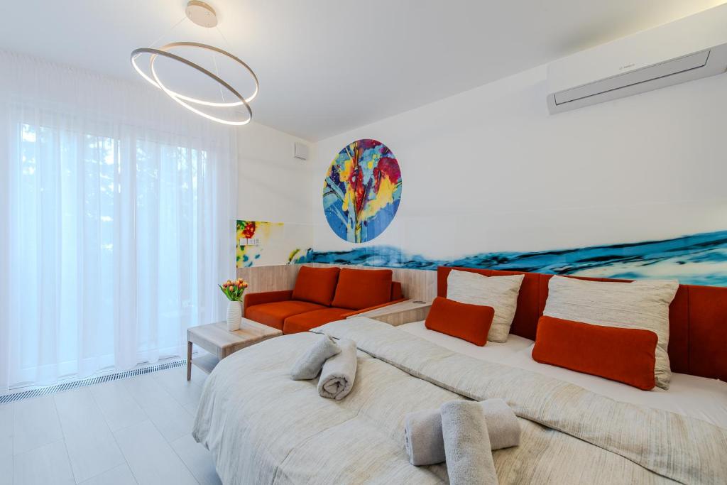 a bedroom with a large bed with an orange couch at PREMIUM Apartments Old Town in Košice